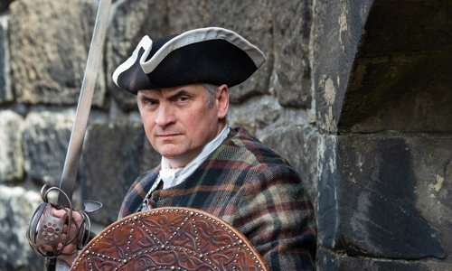 Costumed performer taking the Rebels and Redcoats performance