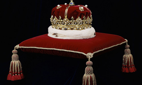 Crown with bonnet on a cushion