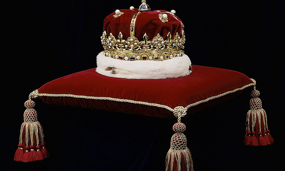 Crown with bonnet on a cushion