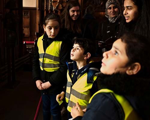 Syrian refugees enjoying a visit to the castle and looking for clues to complete the quiz