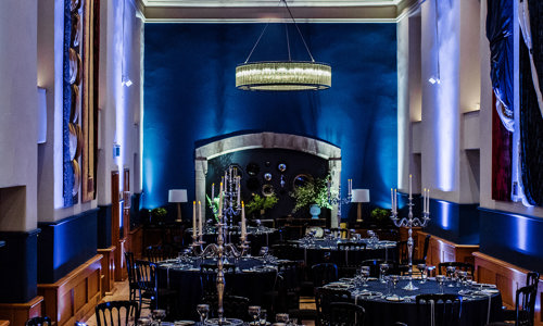 Interior of the Queen Anne Room set up for an evening dinner