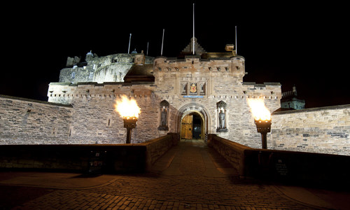 View from the esplanade to the castle at night floodlit and flambeaux lit