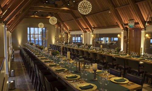 Jacobite Room with a long table covered in green and gold ready for an evening dinner