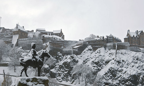 General view of Edinburgh Castle, covered in snow, from Princes Street gardens