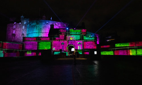 Exterior view of Edinburgh Castle lit up for a Castle of Light evening