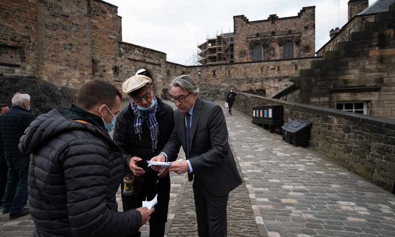 Actor Steve Coogan working with film crew at a castle