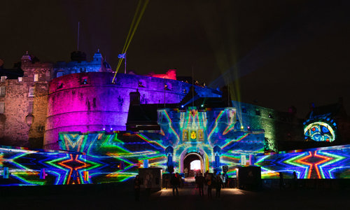 Exterior of Edinburgh Castle with lots of colour and pattern being projected onto it