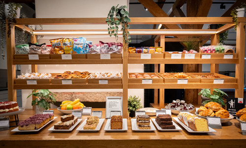 A view of a cake counter with a very tempting display of sweet and savoury treats