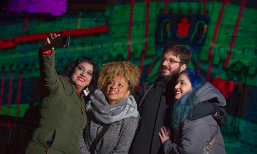 A group of people taking a selfie at castle of light