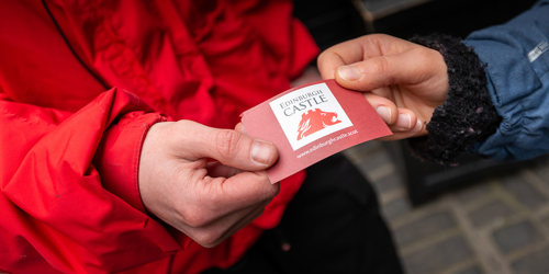 A castle admission ticket being handed over to staff for entry